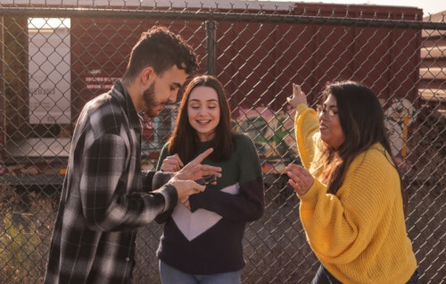 Two young women looking at a phone and smiling